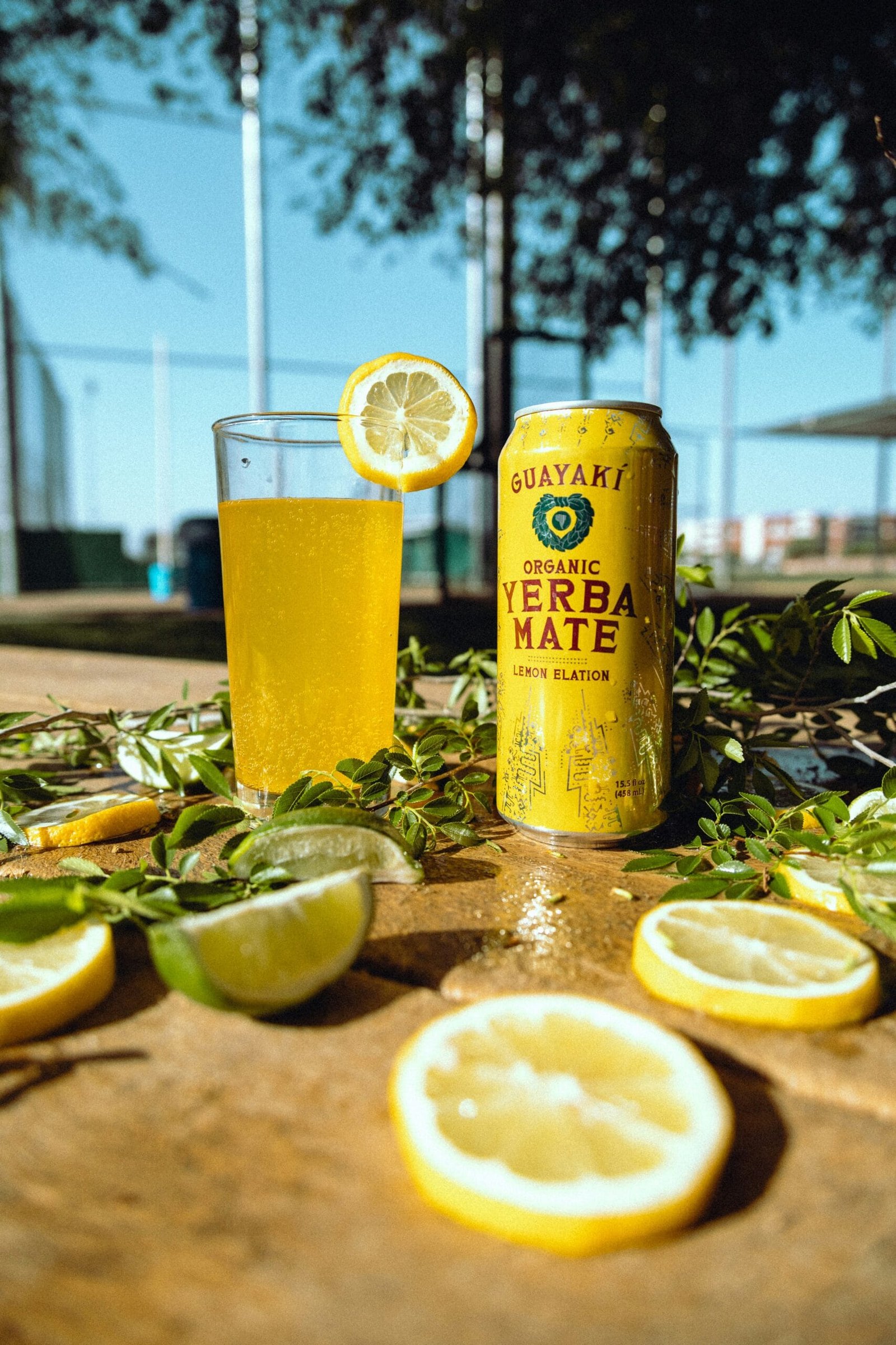 a can of lemonade next to sliced lemons on a table